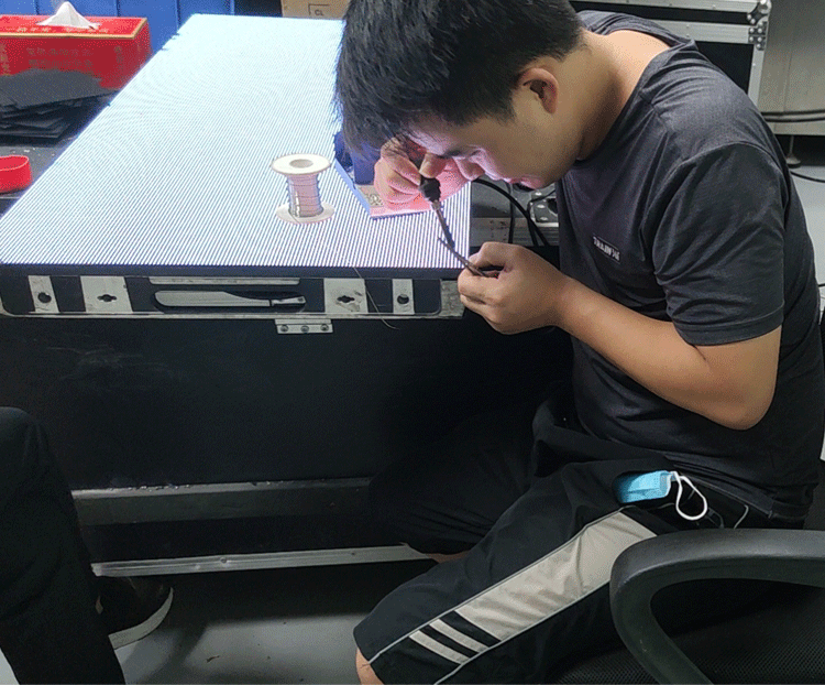 Technicians repairing used LED display panels